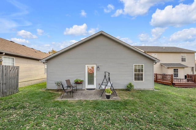 back of property featuring a patio area, a lawn, and a deck