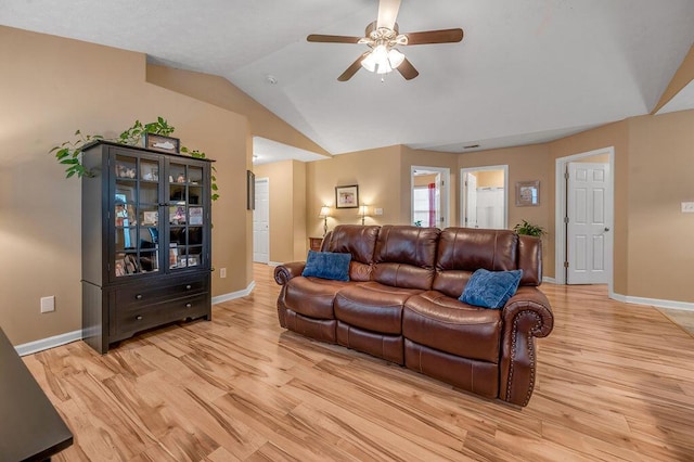 living room featuring vaulted ceiling, light hardwood / wood-style floors, and ceiling fan