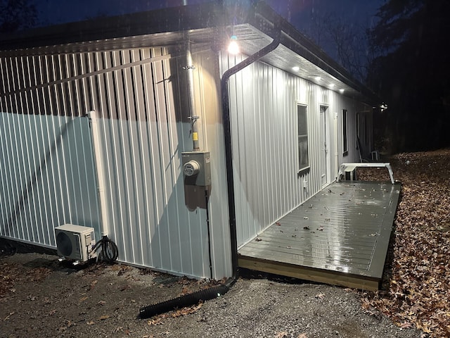 view of property exterior featuring a wooden deck and ac unit