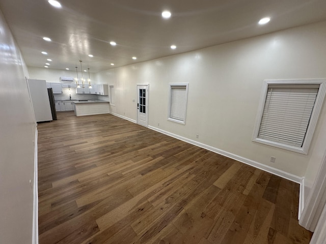 unfurnished living room with dark wood-type flooring