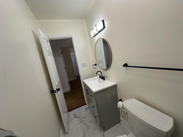 bathroom with vanity, hardwood / wood-style flooring, and toilet