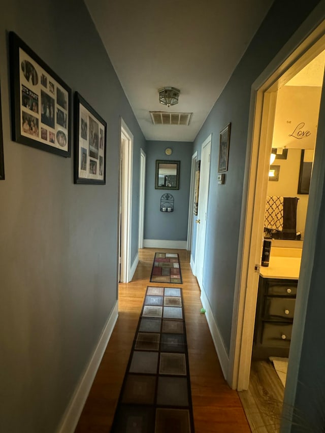 hallway with wood-type flooring