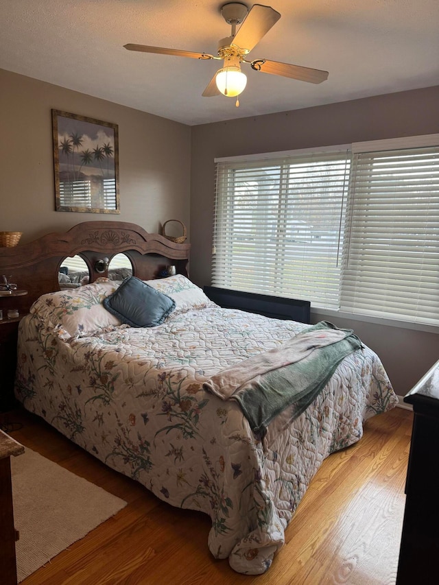 bedroom featuring ceiling fan and light hardwood / wood-style flooring