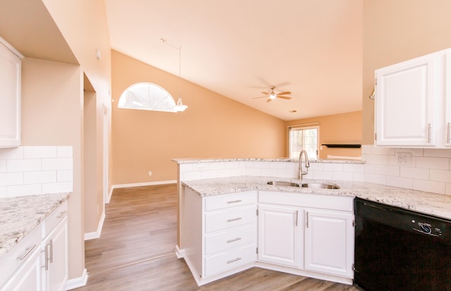 kitchen with white cabinets, vaulted ceiling, sink, and dishwasher