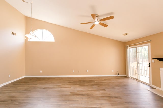 empty room with ceiling fan, wood-type flooring, and high vaulted ceiling