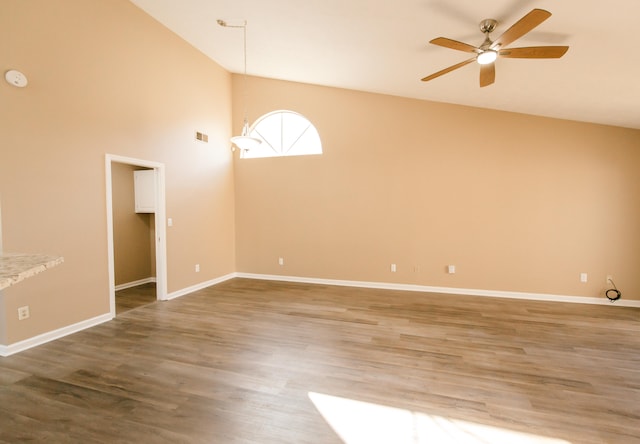 spare room featuring high vaulted ceiling, wood-type flooring, and ceiling fan