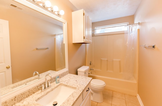 full bathroom with tile patterned floors, vanity, a textured ceiling, toilet, and shower / tub combo with curtain