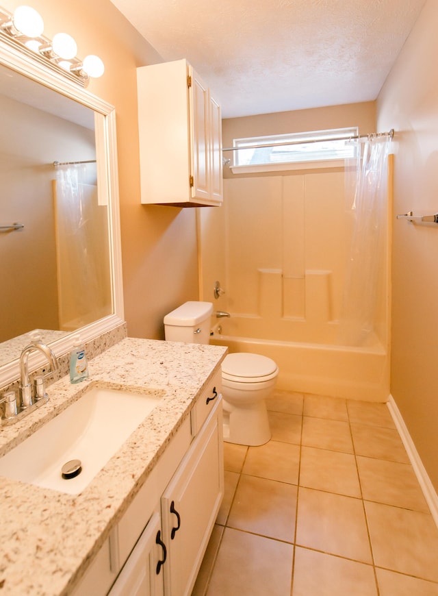 full bathroom featuring shower / bath combination with curtain, a textured ceiling, vanity, tile patterned floors, and toilet