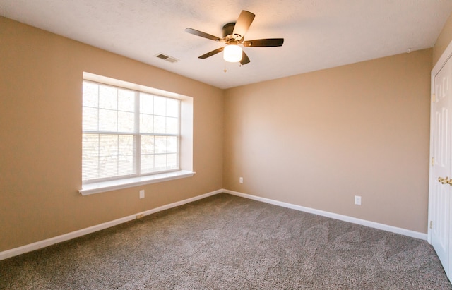 empty room featuring carpet flooring and ceiling fan