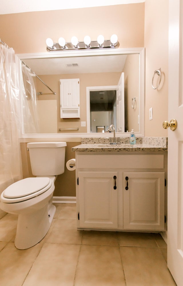 full bathroom featuring toilet, vanity, shower / bath combination with curtain, and tile patterned floors