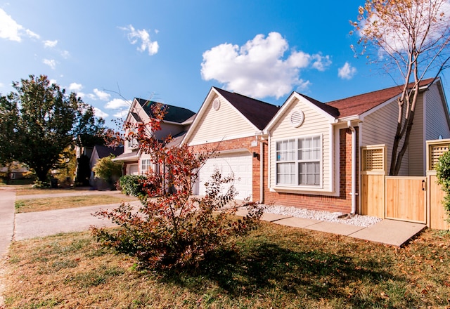 ranch-style house featuring a garage and a front yard