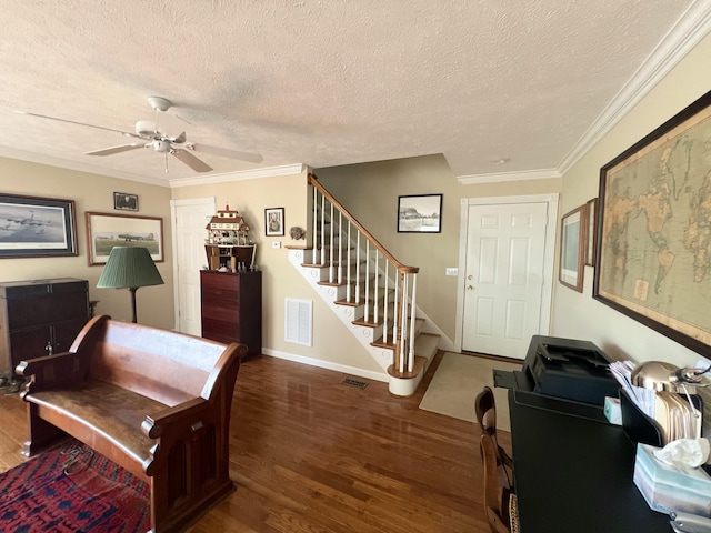 office with dark wood-type flooring, ceiling fan, a textured ceiling, and ornamental molding