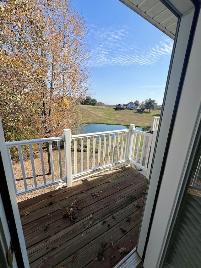 wooden terrace featuring a water view