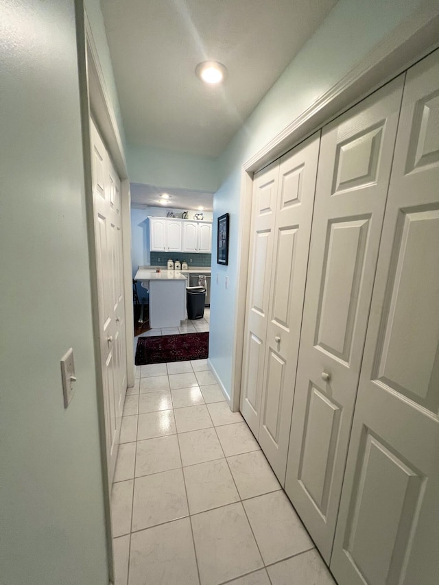 hall featuring light tile patterned floors