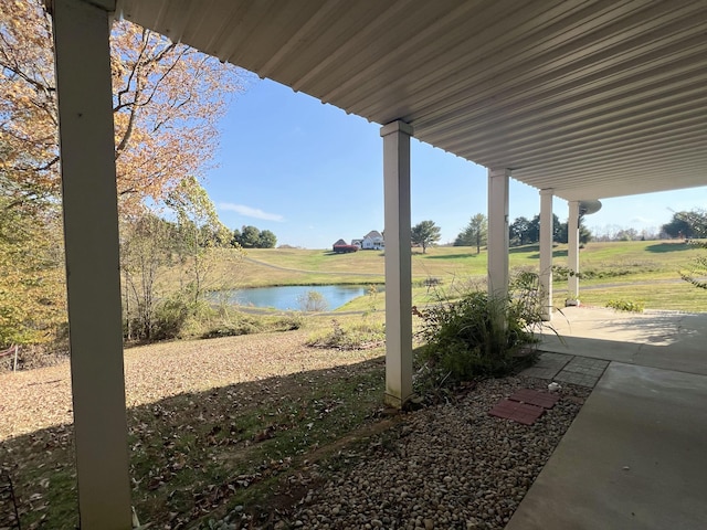 view of yard with a water view and a patio area