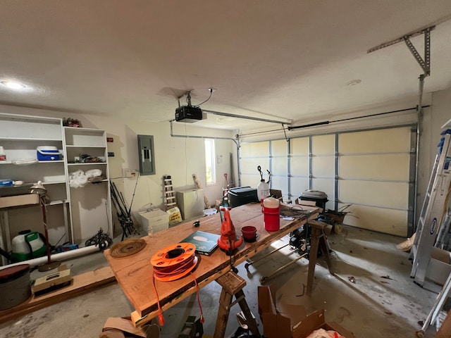 garage with a garage door opener and electric panel