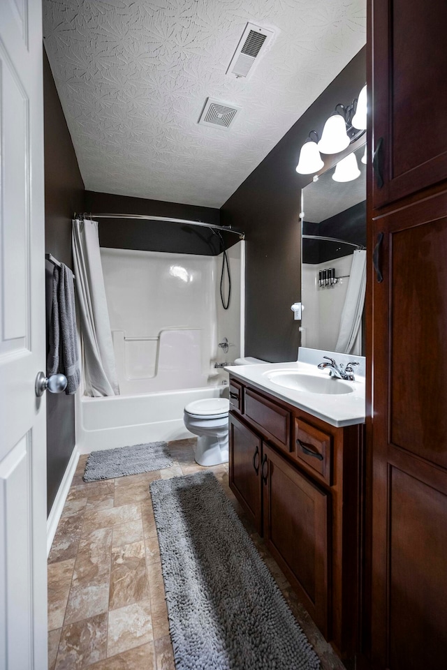 full bathroom featuring vanity, shower / bath combo, a textured ceiling, and toilet