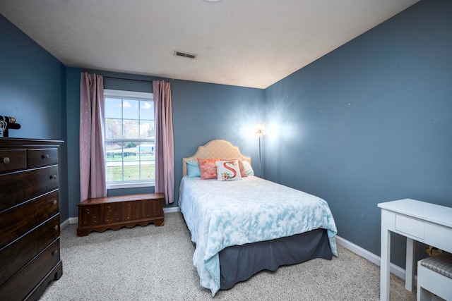 carpeted bedroom with a textured ceiling