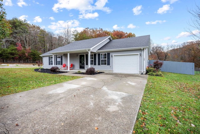 single story home featuring covered porch, a front lawn, and a garage