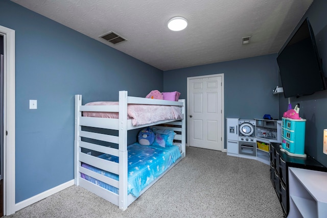 bedroom featuring carpet flooring and a textured ceiling