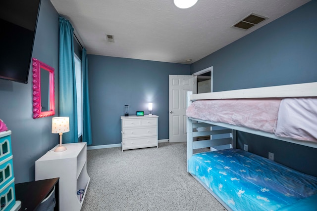 bedroom with carpet and a textured ceiling