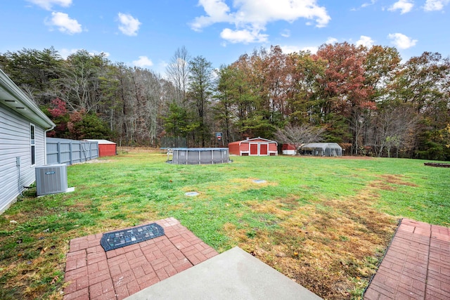 view of yard with a patio, cooling unit, and a storage unit