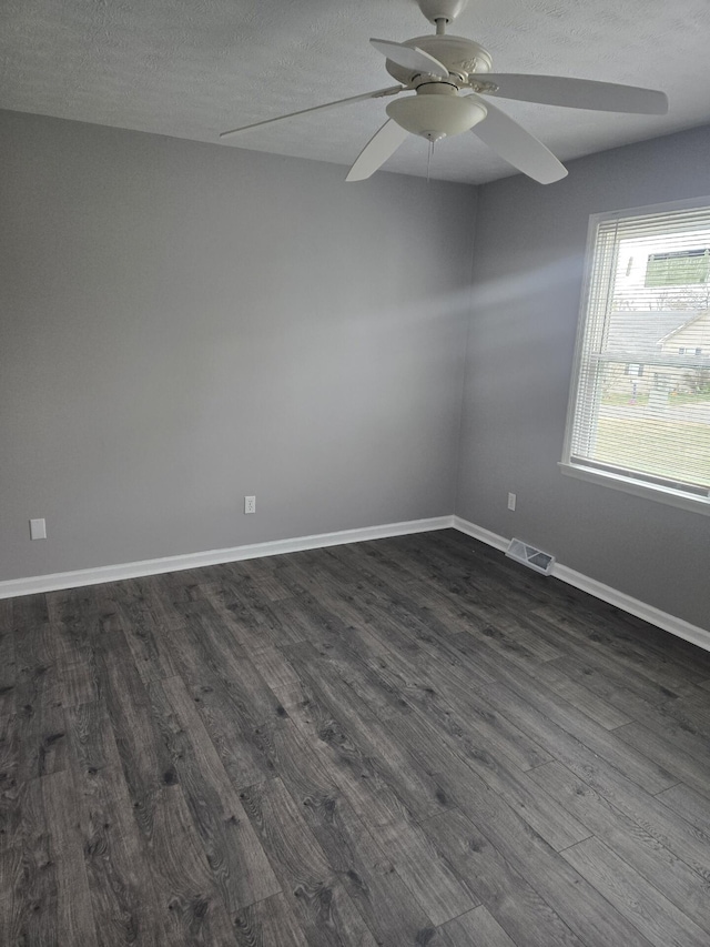 unfurnished room with a textured ceiling, dark hardwood / wood-style flooring, and ceiling fan