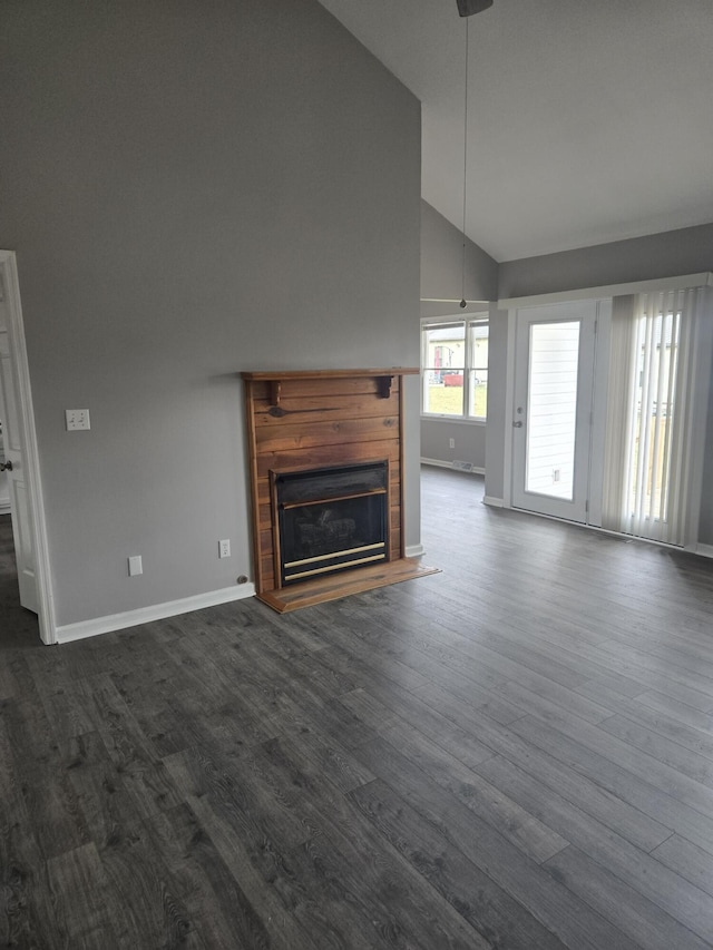 87 Cardinal Cir, Lancaster, KY 40444 - unfurnished living room featuring baseboards, a glass covered fireplace, dark wood finished floors, and high vaulted ceiling