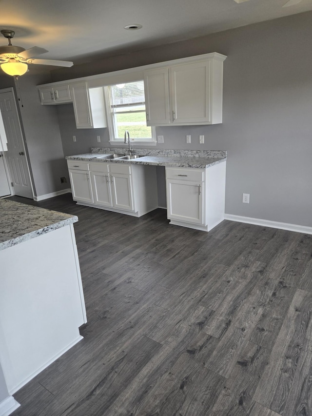 kitchen featuring white cabinetry, sink, dark hardwood / wood-style floors, and ceiling fan