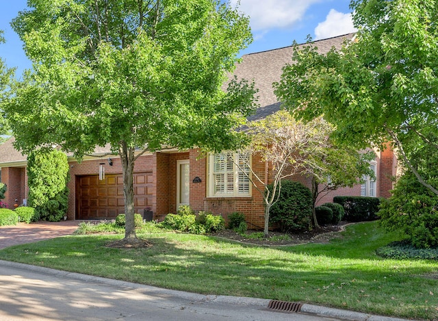 view of front facade with a garage and a front lawn