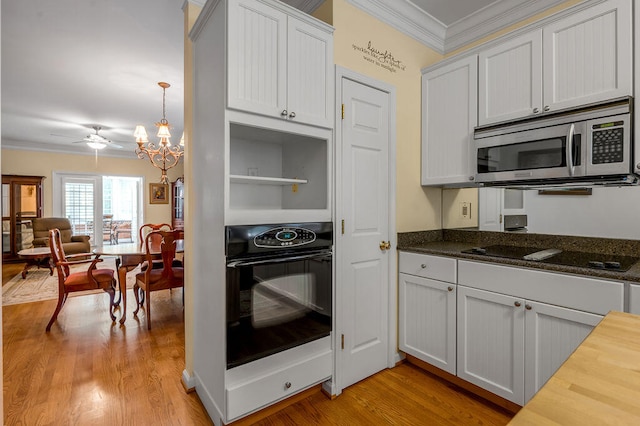 kitchen with black appliances, light hardwood / wood-style flooring, crown molding, and white cabinets