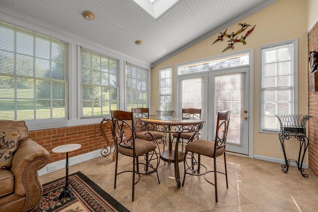 sunroom / solarium featuring plenty of natural light, lofted ceiling with skylight, and wooden ceiling