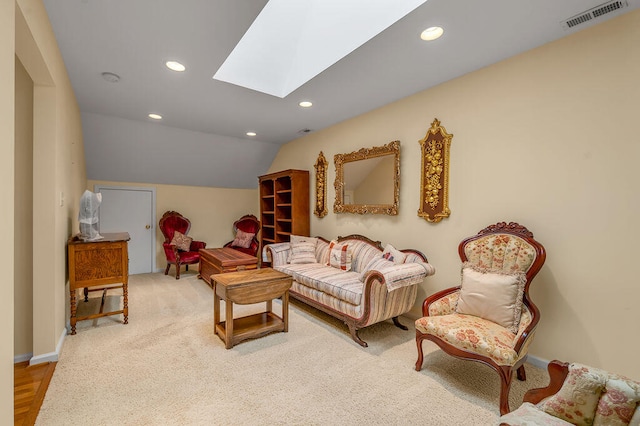 living room featuring lofted ceiling with skylight and hardwood / wood-style flooring