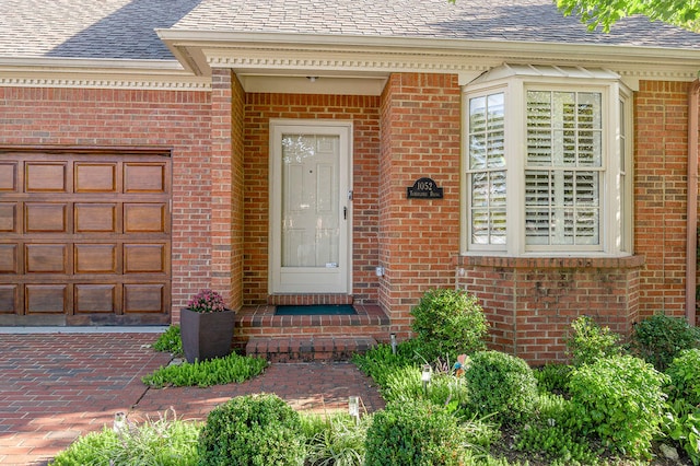 view of exterior entry featuring a garage