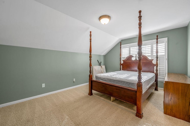 carpeted bedroom featuring lofted ceiling