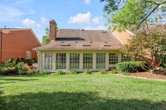 rear view of house with a yard