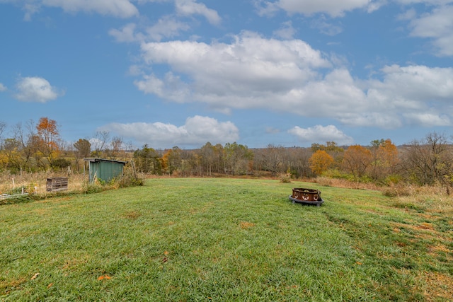 view of yard with an outdoor fire pit