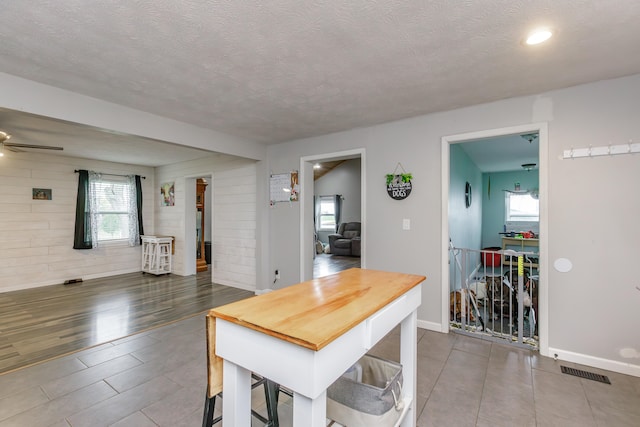 dining room with hardwood / wood-style flooring and a textured ceiling