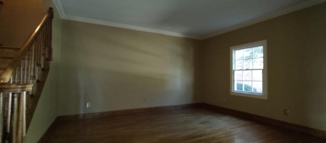 empty room featuring ornamental molding and hardwood / wood-style floors