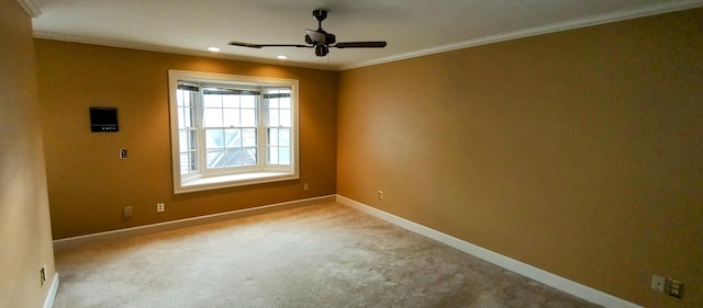 unfurnished room with ceiling fan, crown molding, and light colored carpet