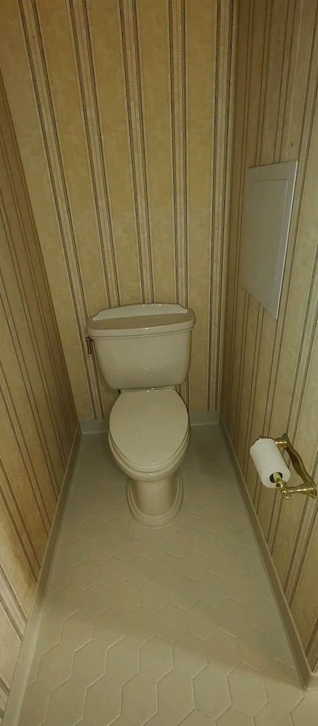 bathroom featuring tile patterned flooring and toilet