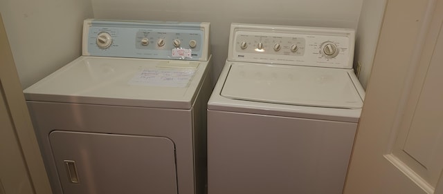 clothes washing area with washing machine and dryer