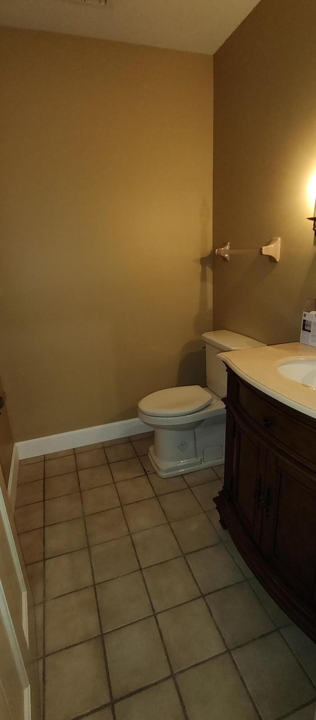 bathroom featuring vanity, tile patterned floors, and toilet