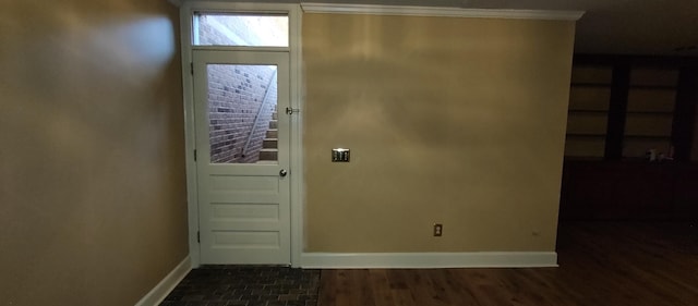 doorway to outside featuring dark wood-type flooring and ornamental molding