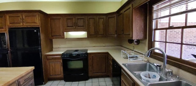 kitchen with extractor fan, black appliances, sink, and light tile patterned flooring