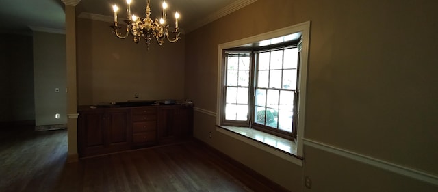 dining room featuring dark wood-type flooring, a chandelier, and crown molding