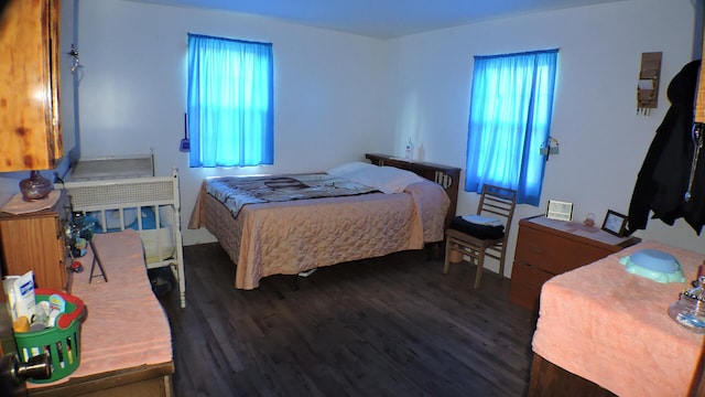 bedroom with dark hardwood / wood-style flooring