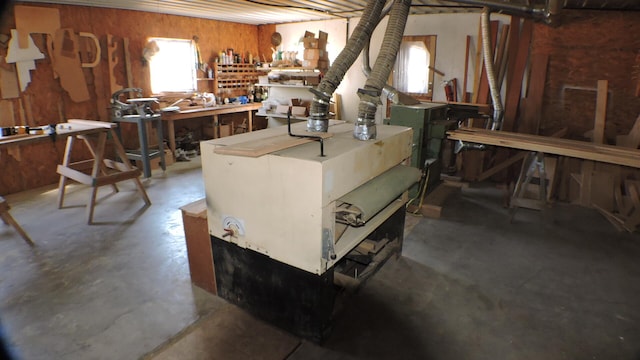 basement with wooden walls and a workshop area