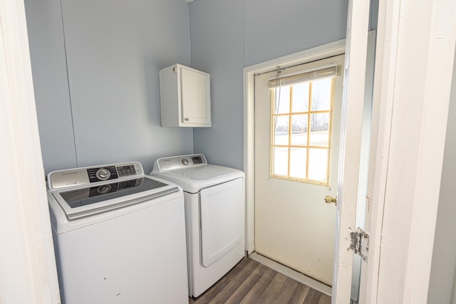 clothes washing area featuring washing machine and dryer and dark wood-type flooring