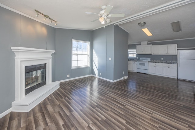 unfurnished living room featuring crown molding, dark hardwood / wood-style floors, a textured ceiling, and a healthy amount of sunlight